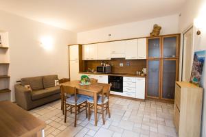 a kitchen and living room with a table and a couch at Da ME in Aosta +11 photos