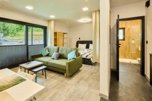 a living room with a couch and a bedroom at Apartamenty w Żywcu u Astrid in Żywiec