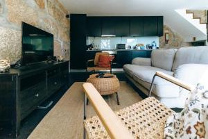 a living room with a couch and a table at Casas de Mirão in Baião