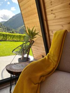 a yellow blanket on a chair on a porch with a table at The Peak in Zărneşti