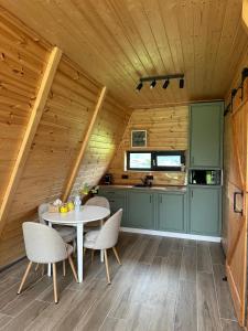 a kitchen with a table and chairs in a cabin at The Peak in Zărneşti