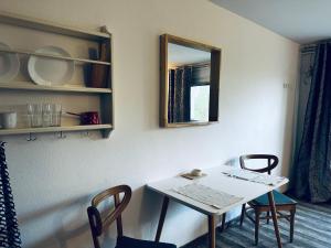 a table and chairs in a room with a mirror at Bright Side Studios in Ljubljana +24 photos