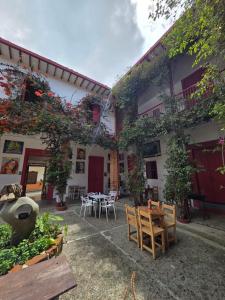 a courtyard with tables and chairs in a building at Republicano Hostal in Jericó