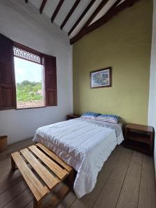 a bedroom with a large bed and a window at Republicano Hostal in Jericó +3 photos