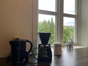 a blender sitting on a table in front of a window at Spacious Apartment - Central Voss - Free Parking in Vossevangen