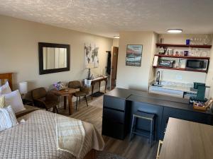 a hotel room with a bed and a desk and a kitchen at little mountain haven in Mount Torry Furnace +22 photos