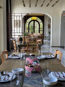 a dining room with a table with plates and silverware at Villa Borgo Musolino in Messina