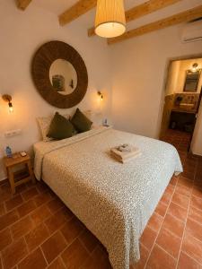 a bedroom with a large bed with a large mirror at Encanto Guesthouse in Canillas de Aceituno +76 photos