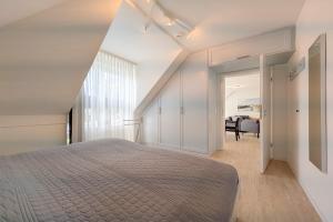a bedroom with a bed and a living room at Residenz Seestern Wohnung 32 in Boltenhagen +31 photos