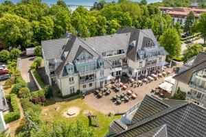 an aerial view of a large house with a patio at Residenz Seestern Wohnung 32 in Boltenhagen
