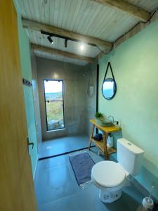 a small bathroom with a toilet and a window at Cloud Valley in Bom Jardim da Serra