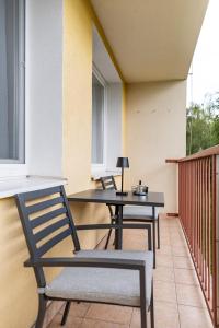 a patio with two chairs and a table on a balcony at MCK Apartments in Košice