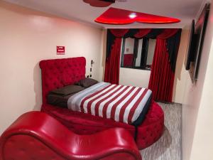 a bedroom with a red bed and a red chair at hostal las vegas 3 in Quito