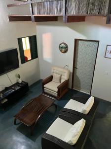 a living room with a couch and a chair at Refúgio Mundo dos Pássaros in Sao Jorge