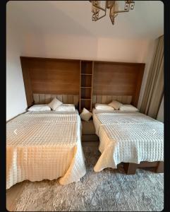 two beds sitting next to each other in a bedroom at Studio Alamein towers in El Alamein +3 photos