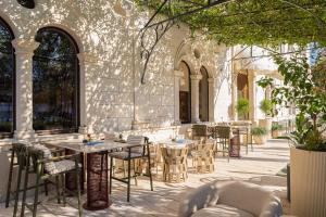 a patio with tables and chairs in a building at Aminess Younique Korcula Heritage Hotel in Korčula +49 photos