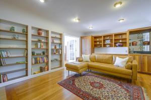 a living room with a couch and bookshelves at Charming Waterfront Home with Mt Rainier View in Olympia