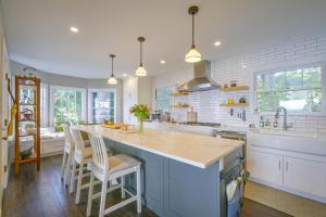 a kitchen with a large island with a counter top at Charming Waterfront Home with Mt Rainier View in Olympia
