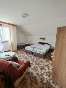 a living room with two beds and a couch at Kordíky in Kordíky