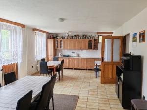 a kitchen and dining room with a table and chairs at Kordíky in Kordíky +26 photos
