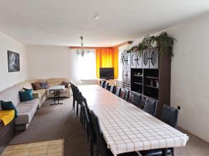 a living room with a long table and chairs at Kordíky in Kordíky