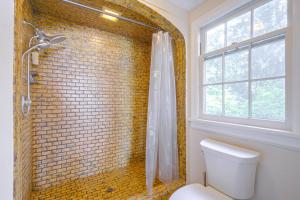 a bathroom with a shower and a white toilet at Charming Waterfront Home with Mt Rainier View in Olympia +27 photos