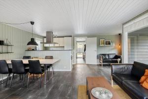 a living room and kitchen with a table and chairs at LF16127-Logstor-Amandasvej-27 in Trend +21 photos