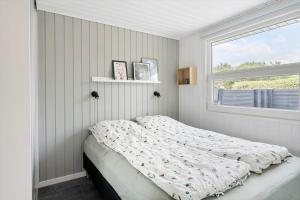 a bed in a bedroom with a window at LF16127-Logstor-Amandasvej-27 in Trend