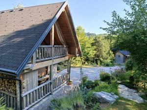 a log cabin with a gambrel roof at Lill' Hill estate & wellness - Lumina Chalet in Idrija