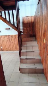a set of stairs in a room with wooden walls at Departamento cercano al centro in Oberá