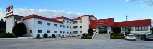 a large white building with a red roof at Hotel Monte Rio Aguieira in Almaça