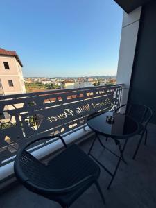 a table and a chair on a balcony with a view at Best House Albania in Kamëz