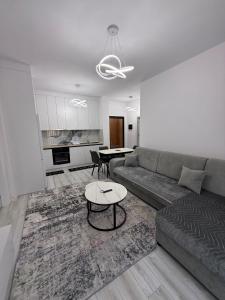a living room with a couch and a table at Best House Albania in Kamëz