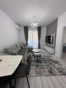 a living room with a couch and a table at Best House Albania in Kamëz