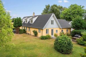 a yellow house with a gray roof at 3309-Stege-Holmemosevej-9 in Stege