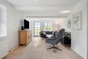 a living room with a chair and a couch at 3309-Stege-Holmemosevej-9 in Stege