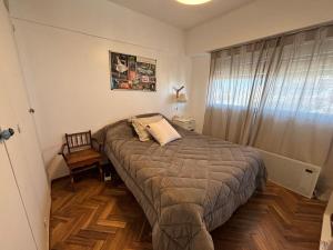 a bedroom with a large bed and a window at my depto in Vicente López