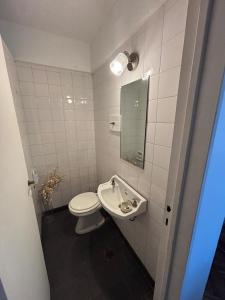 a bathroom with a toilet and a sink at my depto in Vicente López
