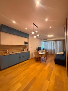 a kitchen and living room with a table and a couch at VOGH Olimp Premium Sea View Escape in Olimp +13 photos
