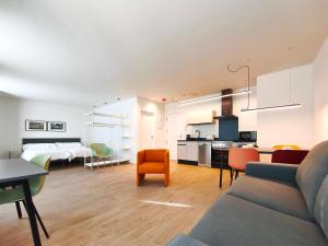 a living room with a couch and a dining room at Apartamentos Mantería Lacort, Valladolid in Valladolid