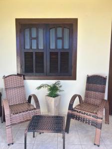 two wicker chairs and a table and a window at Casa à Beira Mar em Praia Seca Araruama RJ in Araruama +76 photos