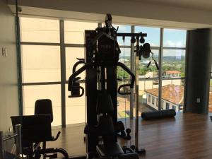 a room with a gym with a large window at Racini Suites Hotel in Boa Esperança