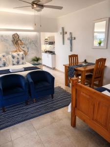 a bedroom with a bed and a dining room at Forget me not Selfcatering Apartments in Nelspruit +32 photos