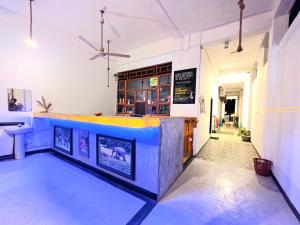 a bar in a restaurant with a blue counter at Yellow bay inn in Arugam Bay