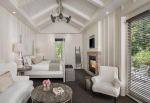 a living room with a couch and a bed and a fireplace at Farmhouse Inn in Forestville +35 photos