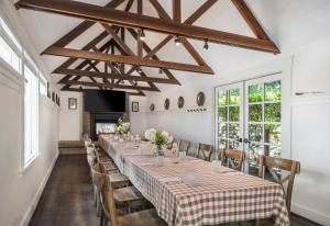 a long dining room with a long table and chairs at Farmhouse Inn in Forestville