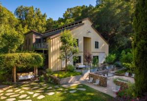 an exterior view of a house with a garden at Farmhouse Inn in Forestville