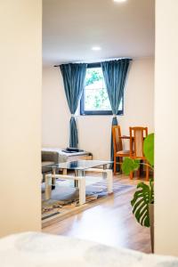 a living room with a couch and a table at Nature Apartment Karlovy Vary Kolová in Karlovy Vary