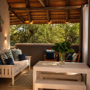 a living room with a table and a couch at Forget me not Selfcatering Apartments in Nelspruit