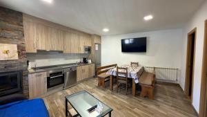 a kitchen with a table and a dining room at Casa Entre Riscos in Corejido
